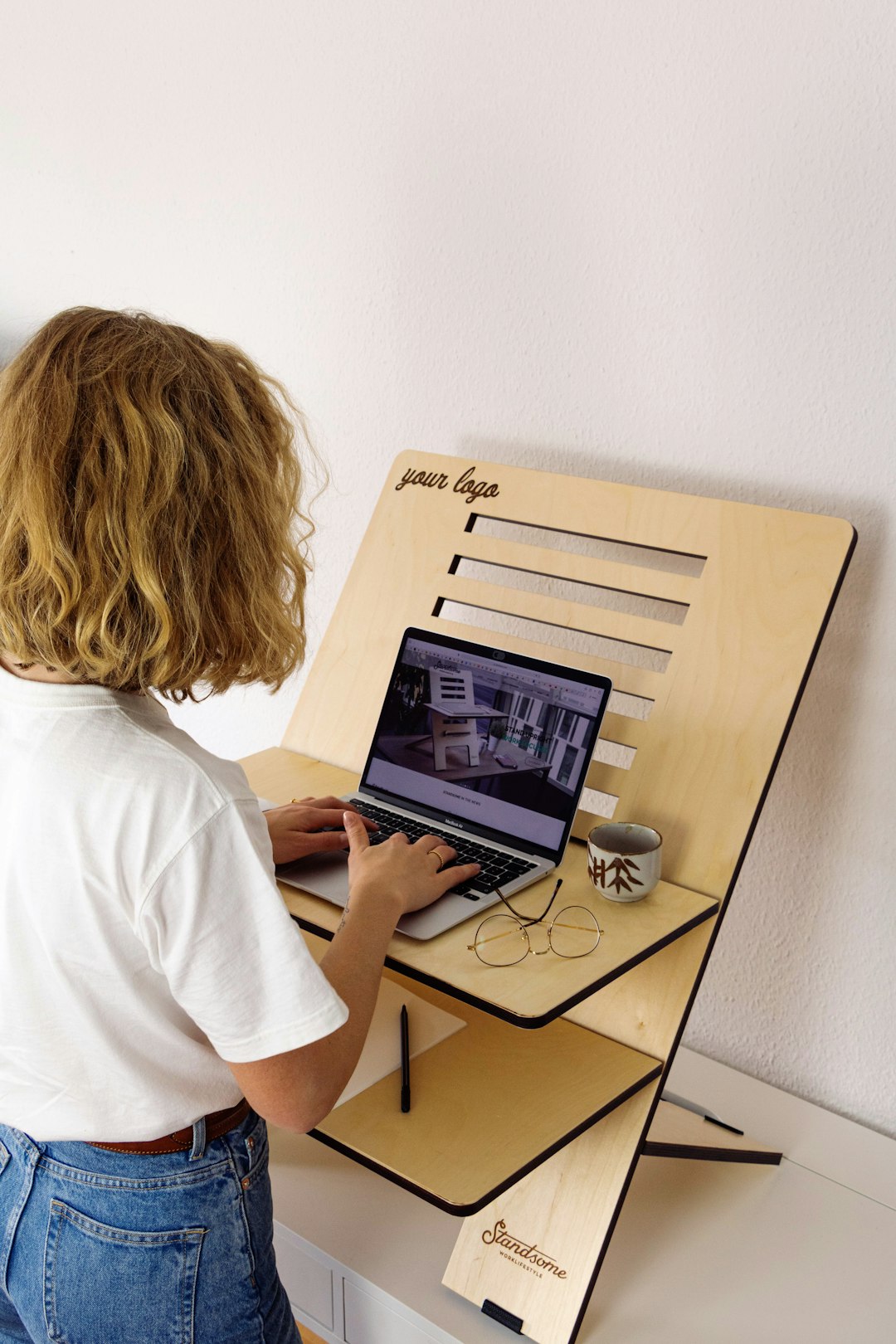 a-child-using-a-laptop-computer-on-a-stand-azhxosubki